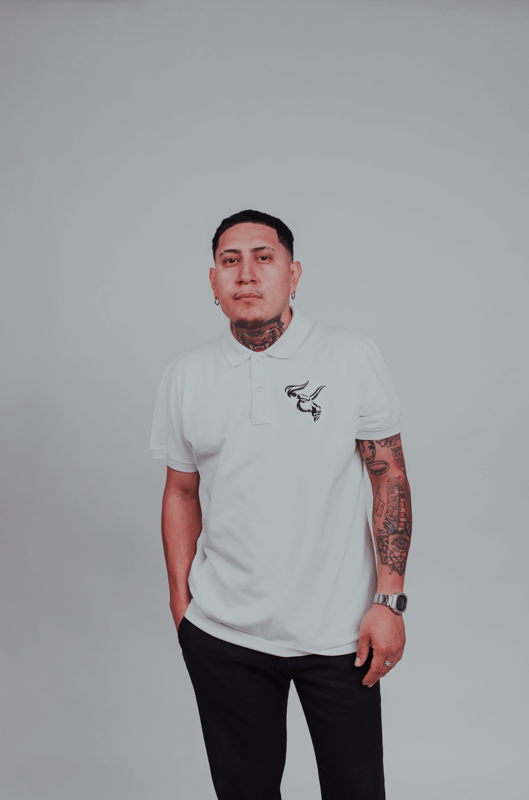 Person wearing BOS-BBS-100 Polo with bull's head design, showcasing short sleeves and a two-button placket in white.